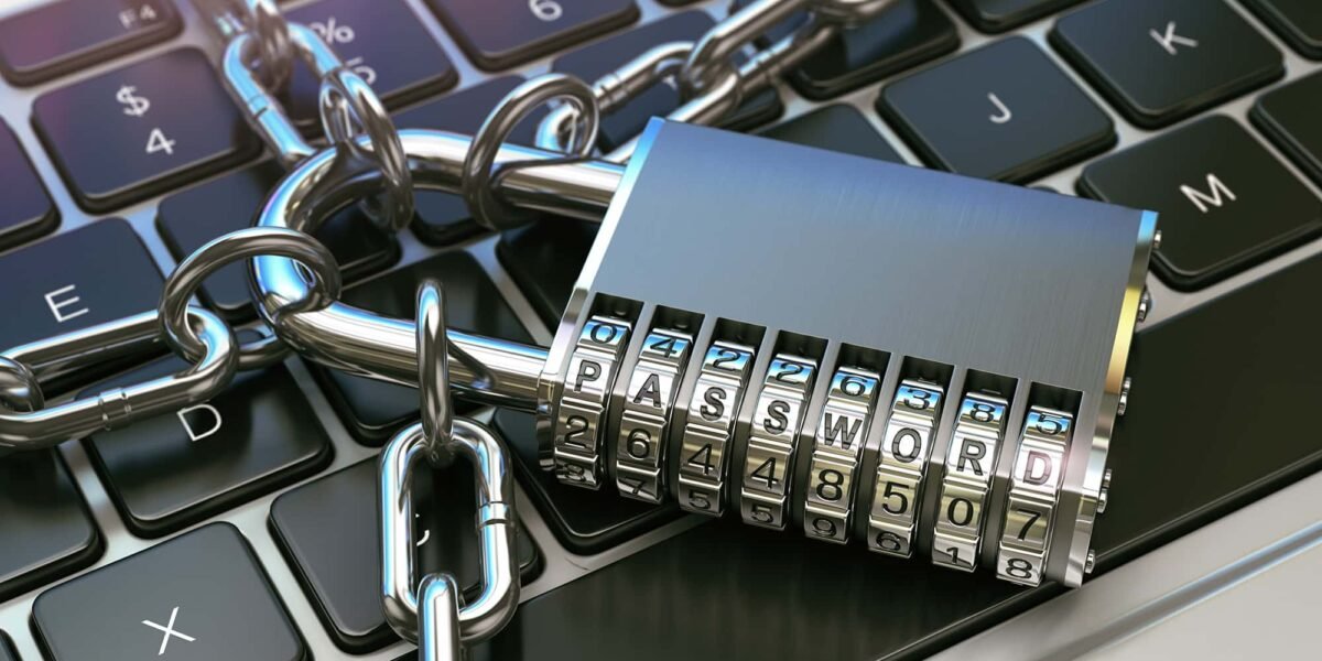 Close-up of a keyboard secured with a chain and combination padlock displaying the word password, symbolizing cybersecurity